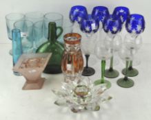 A collection of contemporary coloured glassware, including a green bottle, set of six blue glasses,
