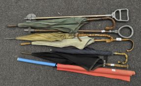 A collection of umbrellas and shooting sticks