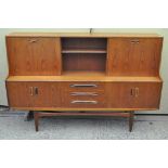 A retro teak sideboard, with drawers and cupboards to the lower tier,