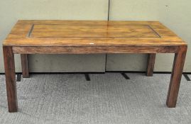 A large mango wood dining table of rectangular form,