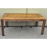 A large mango wood dining table of rectangular form,