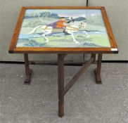 An unusual folding wooden table with embroidered glazed top,