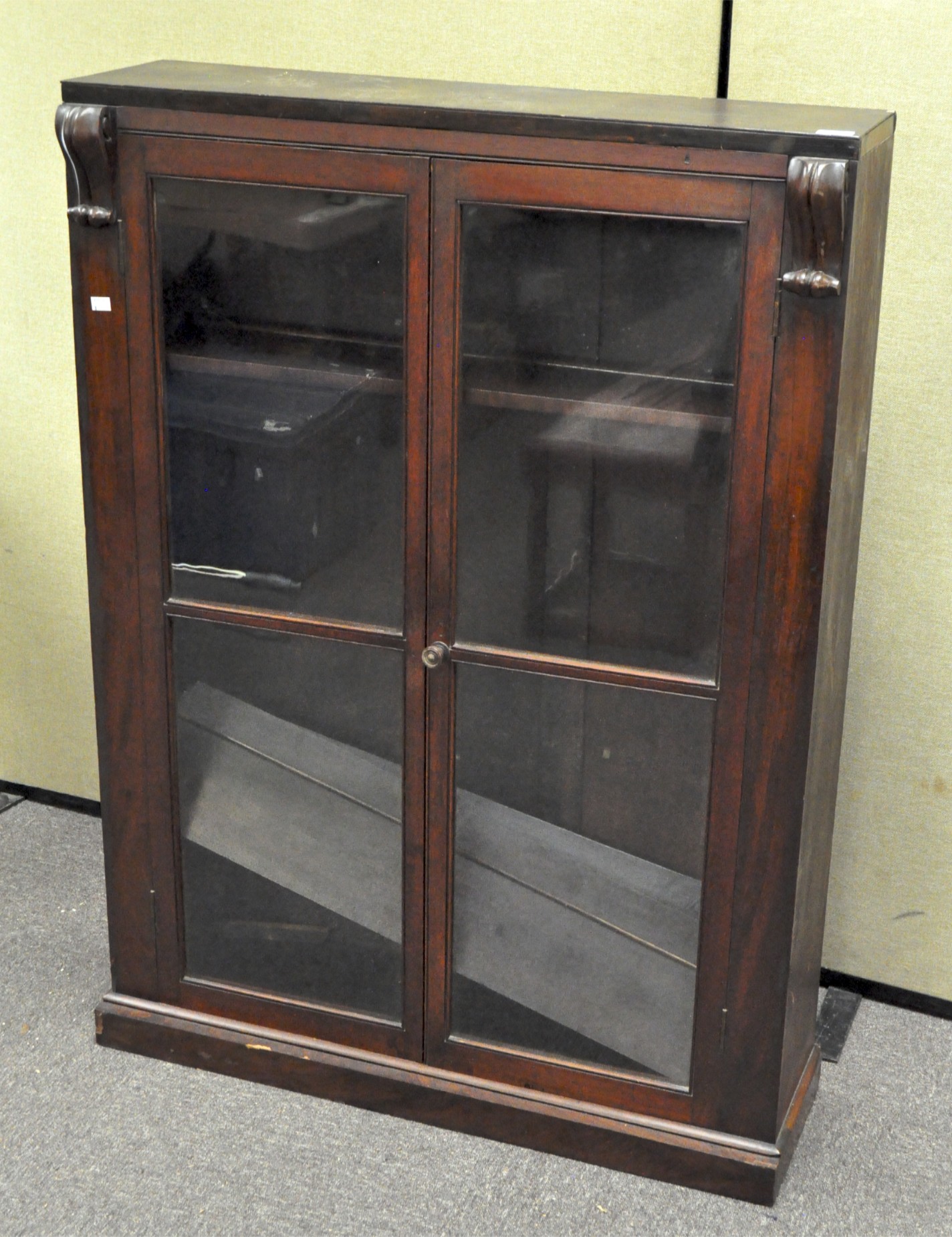 A Victorian mahogany bookcase, two door glazed front, opening to reveal three shelves,