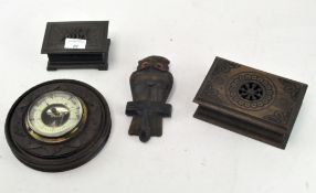 A box of Black Forest carvings, including a brass framed barometer on a carved wooden mount,