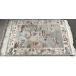 A vintage oriental floor rug, decorated with landscape on blue ground, tassels to two sides,