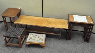 A rectangular coffee table, nest of three tables with glass inset tops, nest of two coffee tables,