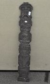 Tribal art: a carved wood totem pole type panel,