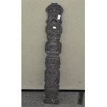 Tribal art: a carved wood totem pole type panel,