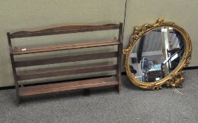 A gilt framed oval mirror with motif decoration,