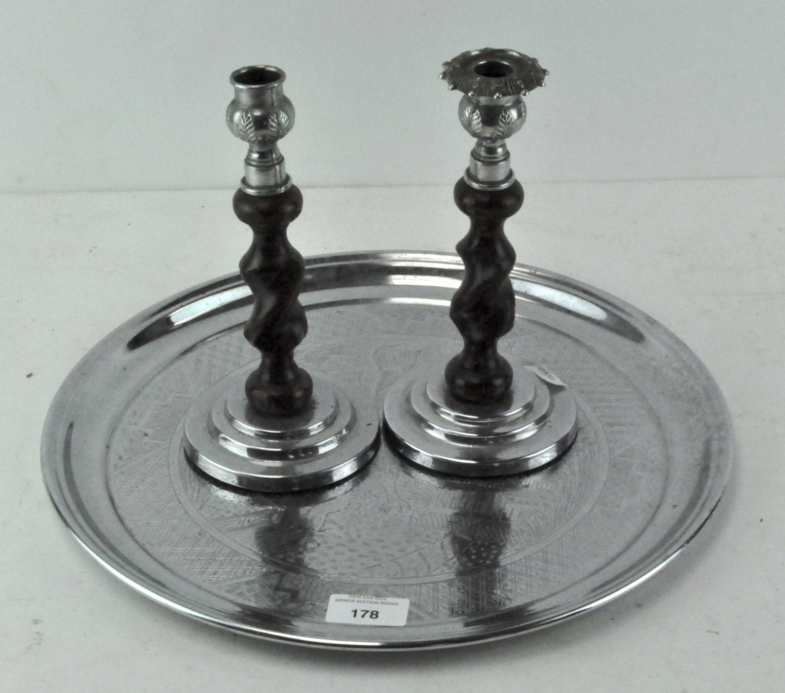 Two candle sticks togther with a tray