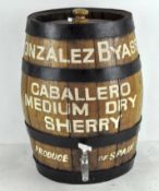 A metal rimmed oak barrel for 'Caballero Medium Dry Sherry' with stopper and a tap to the front,