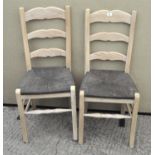 A pair of limed wood dining chairs,