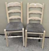 A pair of limed wood dining chairs,