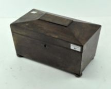 A Victorian oak tea caddy, raised on bun feet with a brass lock,