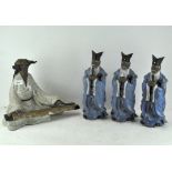 A collection of Chinese figures, three standing and dressed in blue robes,