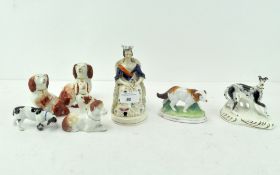 A selection of 19th century ceramic models of dogs, in standing and seated positions,