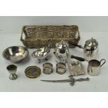 A basket of silver plated wares, to include two hot chocolate pourers,