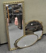 Three gilt framed mirrors, of rectangular, circular and oval form,