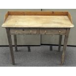 An early 20th century pine desk with two drawers to the front,