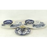 A pair of blue and white teacups in the Willow pattern,