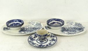 A pair of blue and white teacups in the Willow pattern,