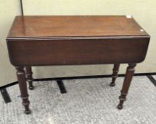 A Victorian mahogany drop leaf table with turned legs,