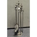 A brass four piece companion set,