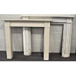 A white painted Edwardian style fire frame surround, with carved details, and another