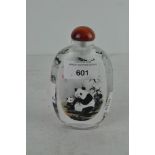 A Chinese reverse painted glass snuff bottle, showing Panda's eating bamboo,