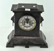 A slate mantel clock the dial inscribed Hry Marc Paris with exposed escapement