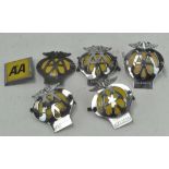 A group of vintage AA car membership badges,