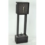 A contemporary slate cased mantel clock, modern, with quartz movement on a square base,