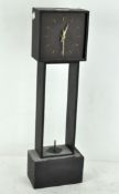 A contemporary slate cased mantel clock, modern, with quartz movement on a square base,