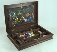 A mahogany artist's box, including a palette, brushes,