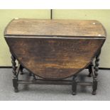 An oak barley twist drop leaf dining table,