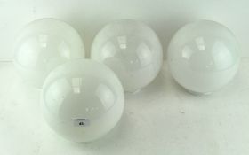 A set of four glass lamp shades, of spherical form,