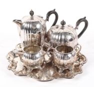 A four piece silver plate tea set and tray, of reeded melon form with scrolling decoration,