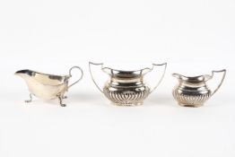 A late Victorian silver half fluted cream jug and sugar bowl,