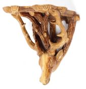 A majolica style wall bracket, late 19th century, modelled as a stags head supporting a shelf,