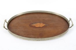 An Edwardian mahogany and inlaid oval tray, with a pierced gallery around a central shell motif,