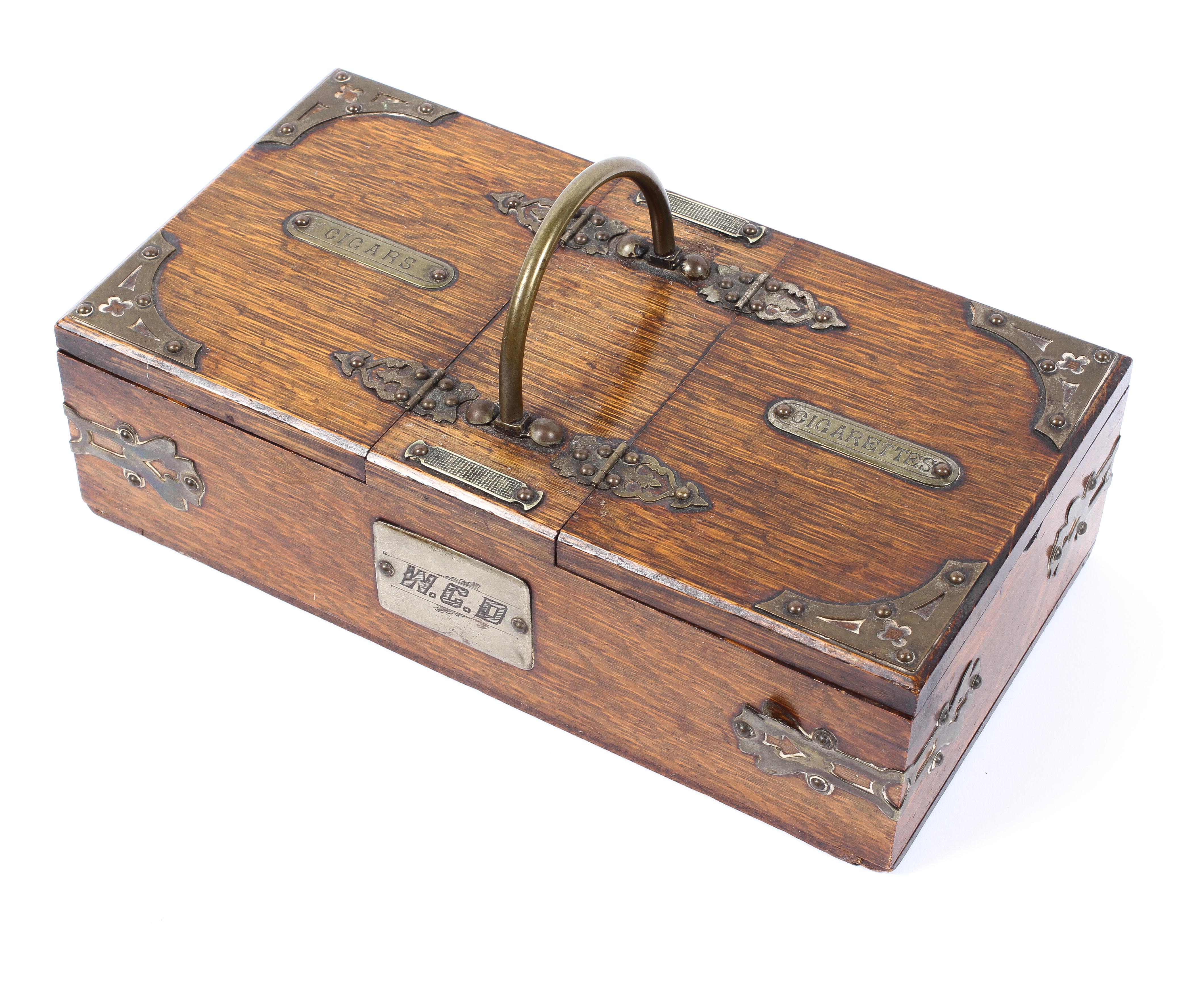 A late 19th century oak cigar and cigarette box, with dual compartments,