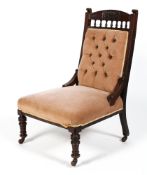 A Victorian nursing chair, with a button back, stuffed over seat and turned front legs,