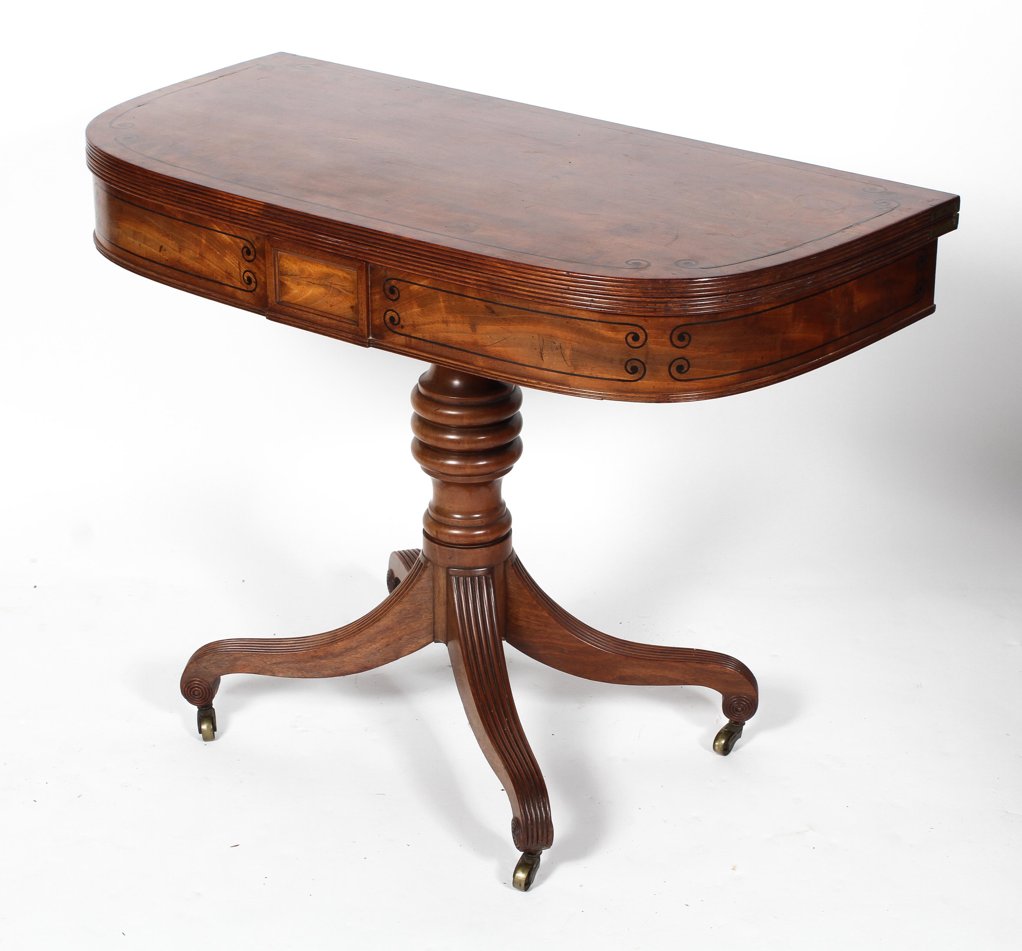 A William IV mahogany and ebony line inlaid fold out card table,