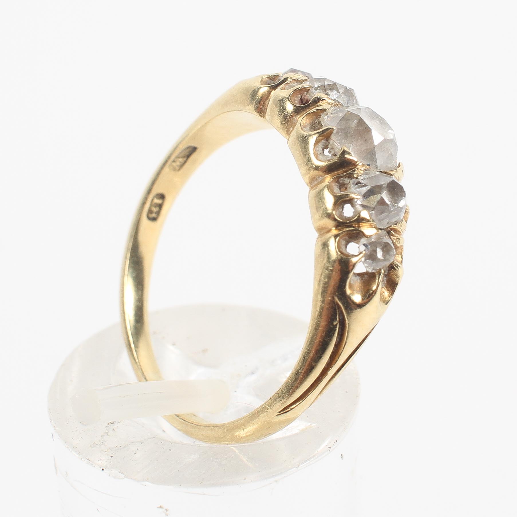 A yellow metal half hoop ring.