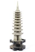 A Chinese soapstone model of a pagoda, 20th century, of hexagonal section with spire stopper finial,