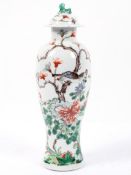 A Chinese Famille Verte vase and cover, of baluster form, painted with a bird in flowering branches,