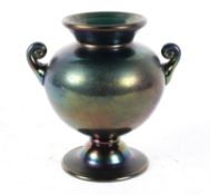An art glass vase, on two handled footed form, the green glass body with iridescent finish,