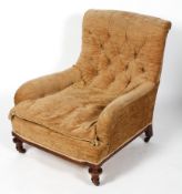 A Victorian Howard and Son style button back armchair, with scrolled arms and turned front legs,