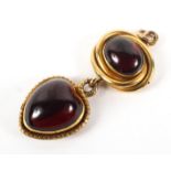 A Victorian gold and garnet mounted two stone pendant,