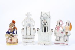 Four Staffordshire pottery figures, circa 1880 including a Wesley Clock group,